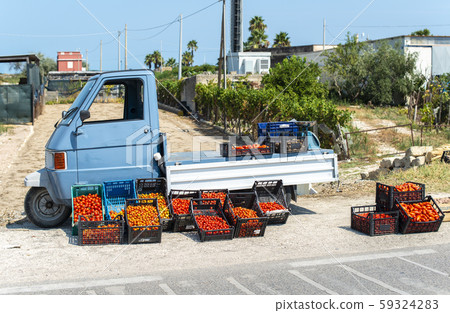Small italian apo truck with tomatoes. Farmer sale 59324283