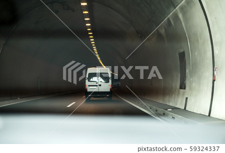 Bus traveling in highway tunnel. 59324337