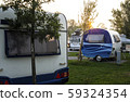 Caravans and campers on green meadow in campsite. 59324354