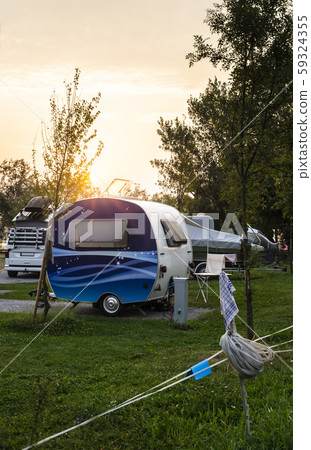 Caravans and campers on green meadow in campsite. Caravans and campers on green meadow in campsite. 59324355