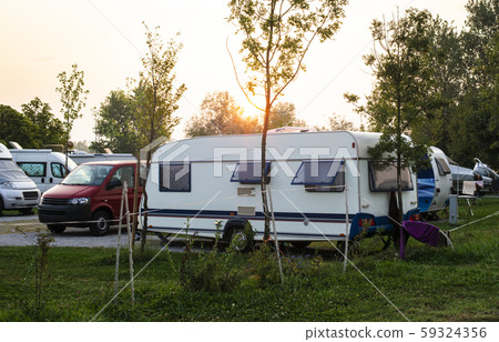 Caravans and campers on green meadow in campsite. Caravans and campers on green meadow in campsite. 59324356
