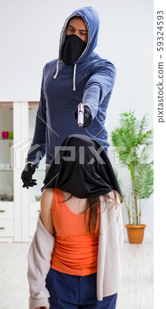 The armed man assaulting young woman at home 59324593