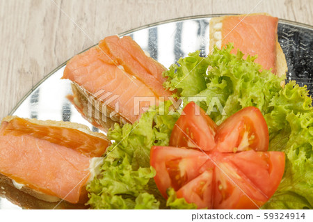 Dish of sandwiches with red fish tomato and greens 59324914