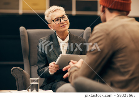 Businesswoman holding business meeting 59325663
