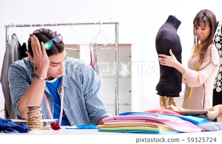 Male tailor with female student in workshop 59325724