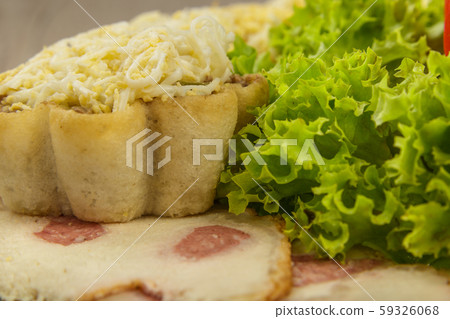 Tartlets with salad on a plate with greens. 59326068