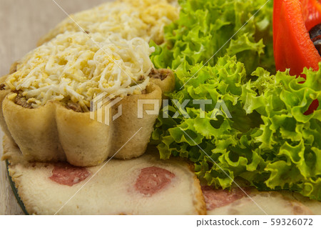 Tartlets with salad on a plate with greens. 59326072