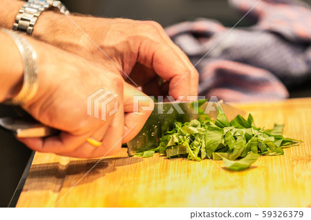 The chef in the kitchen prepares  food 59326379