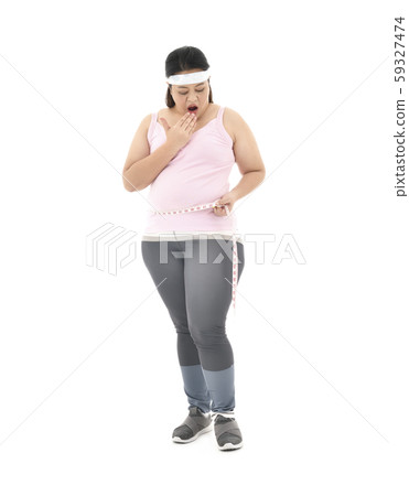Overweight Asian woman measuring her waistline fat tummy isolated on white background 59327474