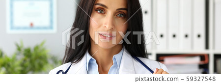 Pretty adult caucasian female GP stretching stethoscope in hands Pretty adult caucasian female GP stretching stethoscope in hands 59327548