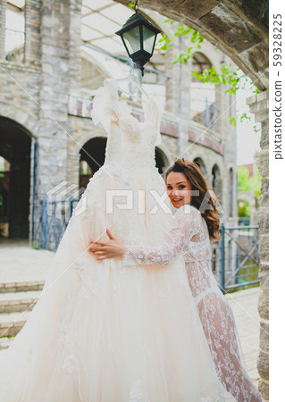 Close-up portrait of young beautiful bride with her bridal dress Close-up portrait of young beautiful bride with her bridal dress 59328225