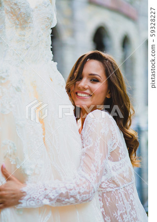 Close-up portrait of young beautiful bride with her bridal dress Close-up portrait of young beautiful bride with her bridal dress 59328227