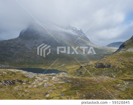 Lake Alnesvatnet with snow capped mountain peak Lake Alnesvatnet with snow capped mountain peak 59328845