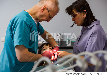people, medicine, stomatology and health care concept - woman patient having dental treatment 59329146