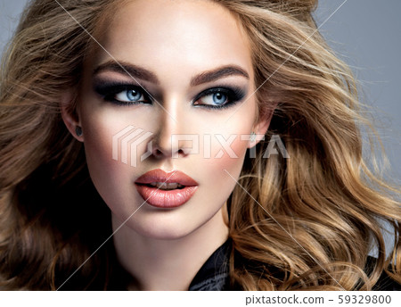 Beautiful blonde girl with makeup in style smoky Beautiful blonde girl with makeup in style smoky 59329800