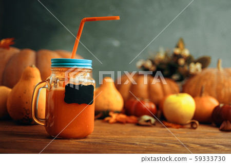 Pumpkins juice in bottles with pumpkins. 59333730