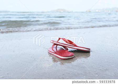 flip flops on beach with wave sandy beach sea flip flops on beach with wave sandy beach sea 59333978