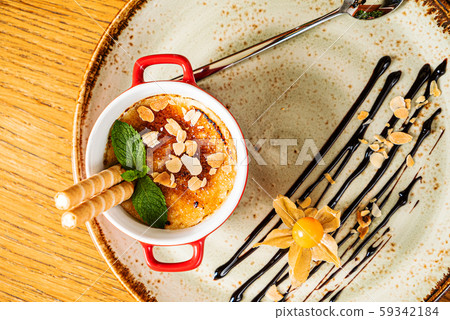 caramel dessert with waffle and physalis 59342184