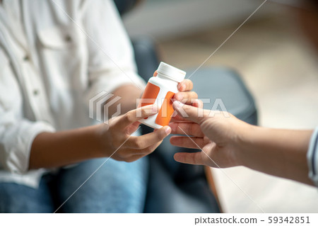 Close up of psychoanalyst giving antidepressant to patient 59342851
