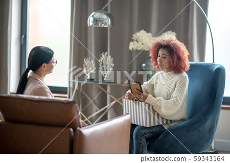 Psychoanalyst listening to young woman telling about child loss Psychoanalyst listening to young woman telling about child loss 59343164