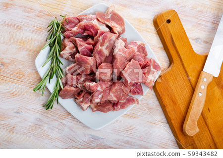 Raw pork neck meat cuts, top view on wooden background Raw pork neck meat cuts, top view on wooden background 59343482