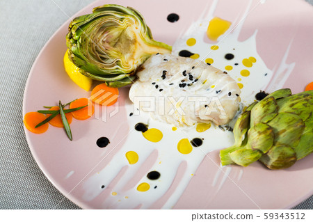 Deliciously fillet of fried horse-mackerel with sauce and artichokes Deliciously fillet of fried horse-mackerel with sauce and artichokes 59343512