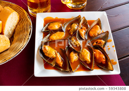 Mussels served with red sauce 59343808