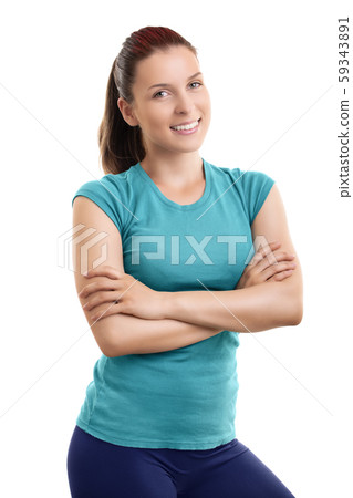 Beautiful fit girl standing with folded arms looking at camera Beautiful fit girl standing with folded arms looking at camera 59343891