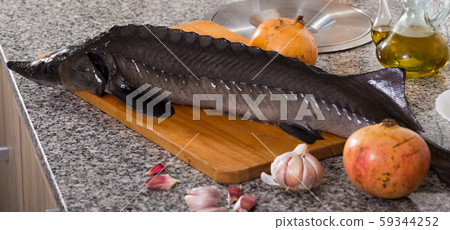 Sturgeon fish on stone surface with pomegranates Sturgeon fish on stone surface with pomegranates 59344252