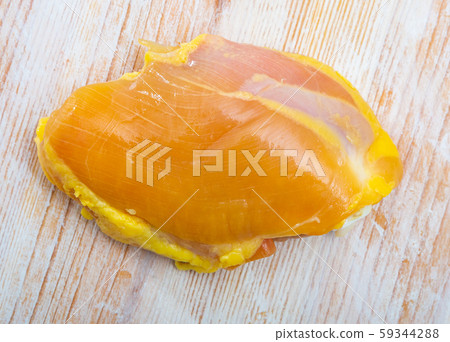 Raw skinless chicken thighs on cutting board 59344288