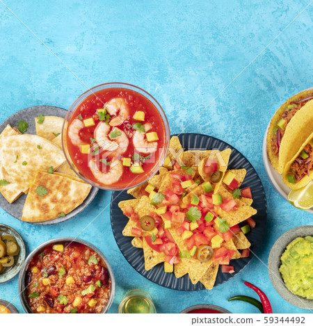 Mexican food, many dishes of the cuisine of Mexico, flat lay overhead square shot on a vibrant blue 59344492