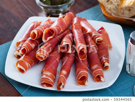 Traditional Spanish meal - rolls of iberian jamon served at plate Traditional Spanish meal - rolls of iberian jamon served at plate 59344565