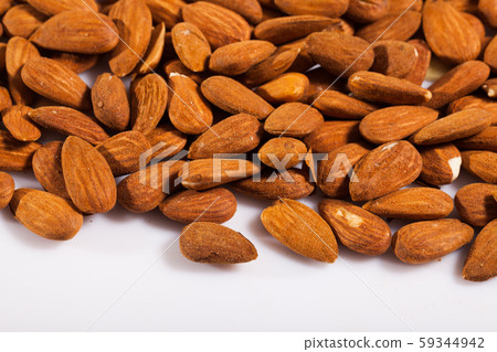 Roasted almonds on white surface Roasted almonds on white surface 59344942