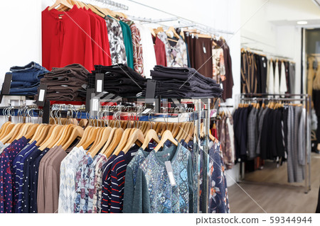 Different clothes on hangers and shelfs Different clothes on hangers and shelfs 59344944