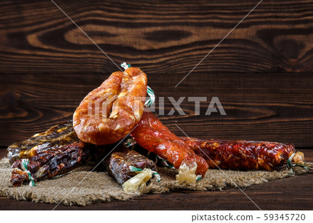 Variety of dried sausage on wooden table 59345720