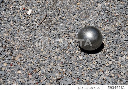 Metallic petanque  ball on the ground 59346281