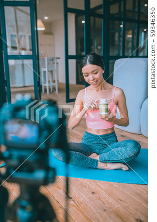 Young fitness blogger filming video about supplements Young fitness blogger filming video about supplements 59346350