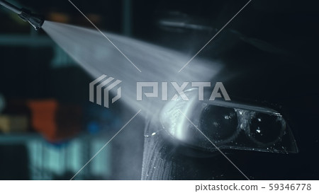 Car headlight wash. Washing modern vehicle body by high pressure jet wash hose water. Auto glass Car headlight wash. Washing modern vehicle body by high pressure jet wash hose water. Auto glass 59346778