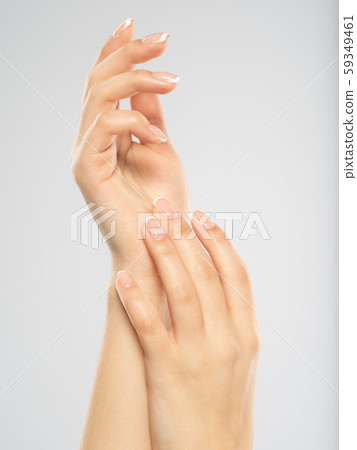 Woman gets manicure procedure in a spa salon. Woman gets manicure procedure in a spa salon. 59349461