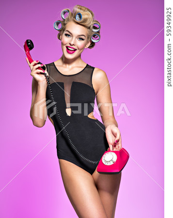 Portrain of an attractive woman using a vintage 59349925