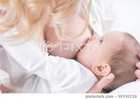 Mother breastfeeding her little baby in her arms 59350159