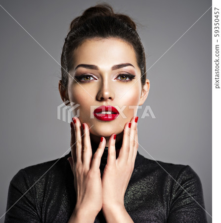 Beautiful woman with bright make-up and red nails. 59350457