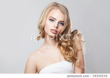 Healthy woman with blonde curly hair on white Healthy woman with blonde curly hair on white 59350559