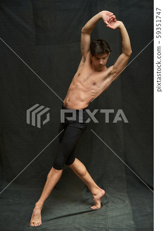 Young ballet dancer in motion on black background Young ballet dancer in motion on black background 59351747