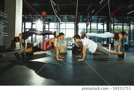A group of muscular athletes doing workout at the gym 59351751