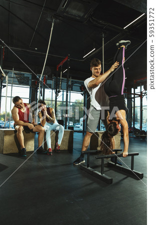 A group of muscular athletes doing workout at the gym A group of muscular athletes doing workout at the gym 59351772