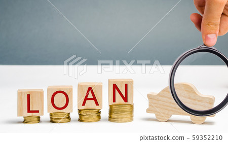 Wooden blocks with coins and the word Loan and a car. The concept of buying a car on credit. Debt for auto. Vehicle. The accumulation of money. Savings. Automobile. Debt growth 59352210