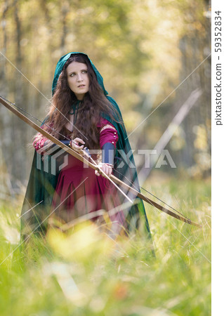 An elf archer with a bow in the woods An elf archer with a bow in the woods 59352834