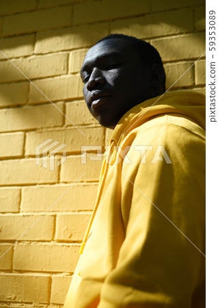 African Male Immigrant Looks At Camera With Serious Expression African Male Immigrant Looks At Camera With Serious Expression 59353089