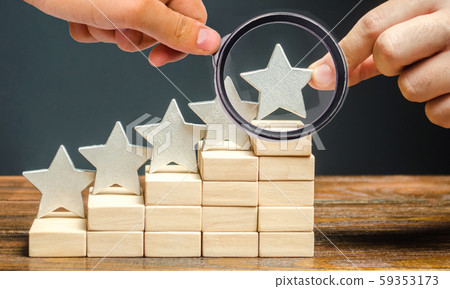 Critic puts the fifth star. The concept of the rating of hotels and restaurants. The evaluation of visitors. Quality level, good service. Best customer rating. Feedback. Satisfaction 59353173